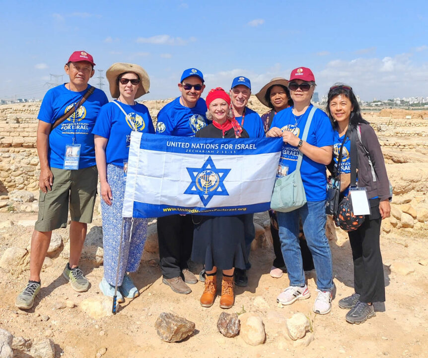 Israel Tour participants holding UNIFY flag